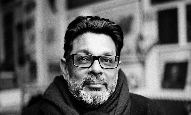 Black and white headshot picture of Shaheen Merali wearing a scarf