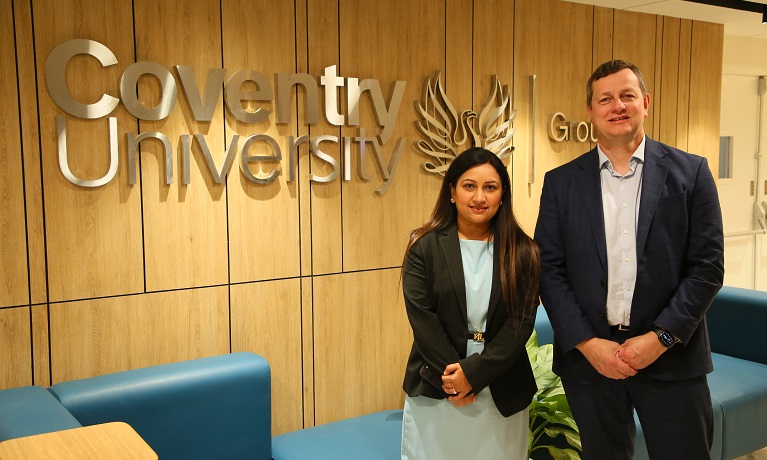 Regional Managing Director for the India Hub, Leena Arora Kukreja, and Deputy Vice-Chancellor (International), Richard Wells, stood infront of a wall-mounted Coventry University logo inside the India Hub