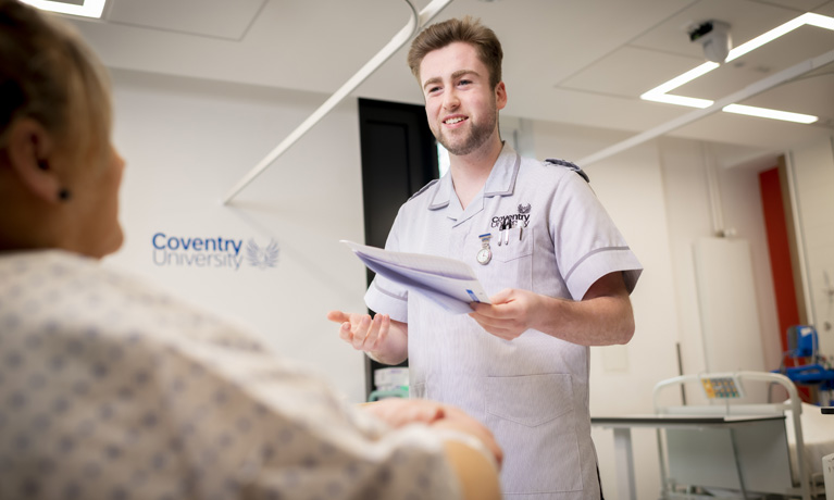 A male nursing student in the mock hospital ward at Coventry University.