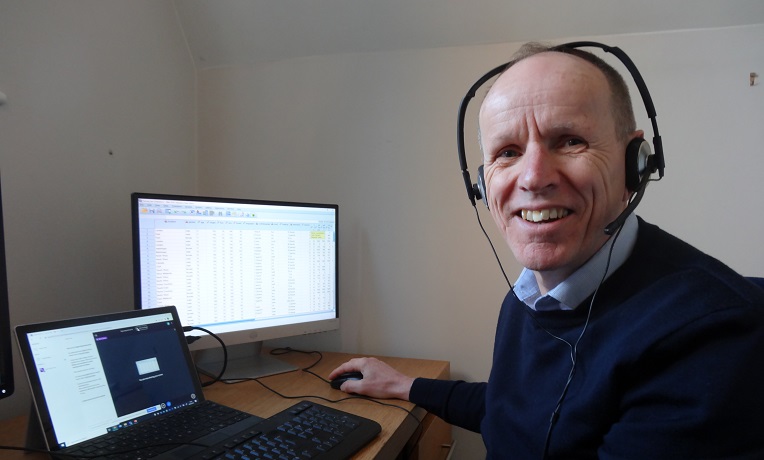 Alun Owen, the head of Coventry University’s Statistics Advisory Service sat next to a computer while wearing headphones