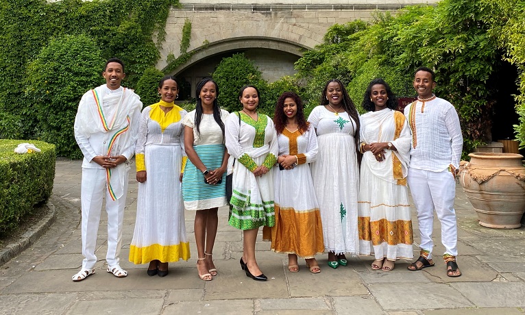 Eight participants of the Chevening Ethiopia Leadership Fellowship stood in a stone courtyard during their visit to Coventry