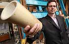 Someone in a suit holding a bit of bamboo