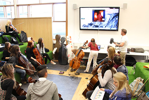 Group of students participating in violin practice