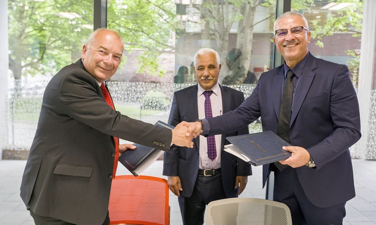 Professor John Latham CBE, Coventry University Vice-Chancellor, shakes hands with Professor Tariq Obaid, President of BSESP, as Mohamed Tahiri, Director of Higher Education at the Moroccan Department of Higher Education, watches on.