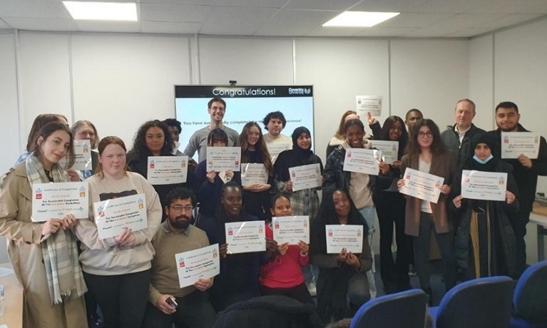 A group of students holding certificates