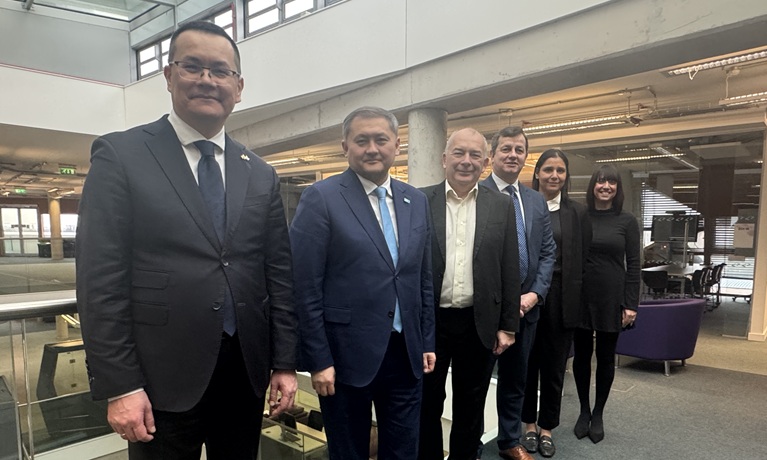 The Kazakhstan Minister of Science and Higher Education stood in a line with Coventry University senior leaders smiling at the camera