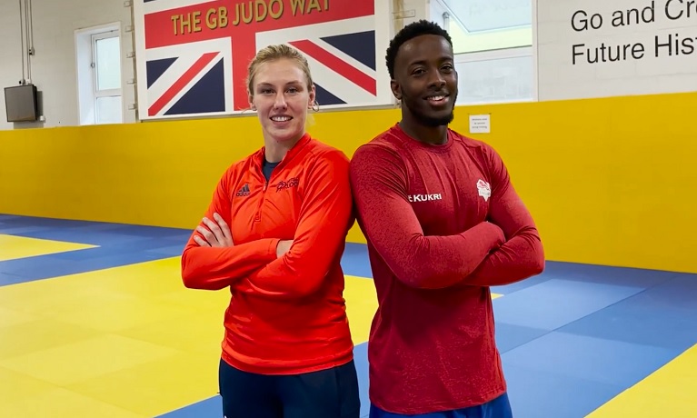 Coventry University graduates Emma and Jamal standing side by side in the gym