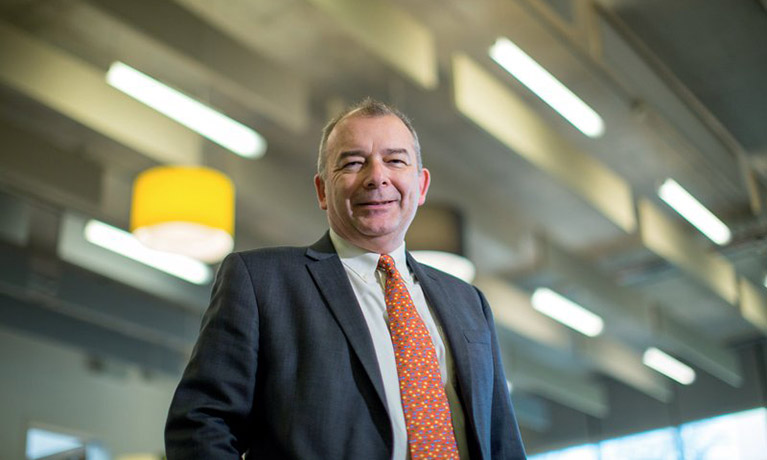 Professor John Latham CBE, Coventry University Vice Chancellor wearing an orange tie