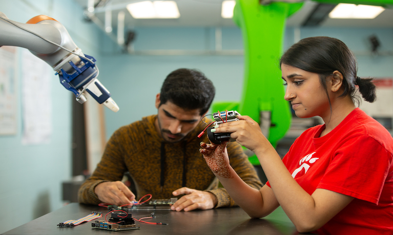 female and male student studying circuit boards