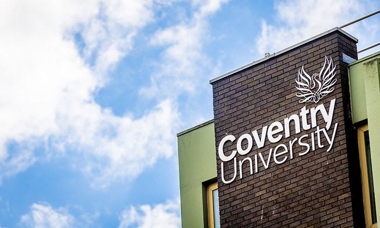 A picture of the Coventry University sign on a building