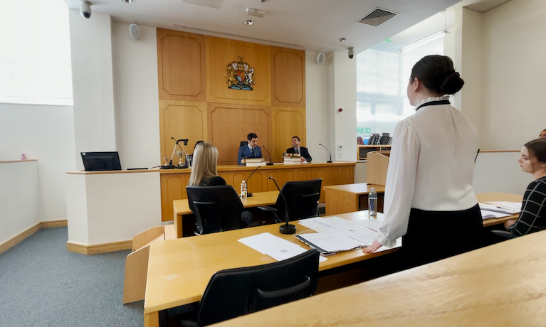 Law student presents in front of witnesses and judge in court room