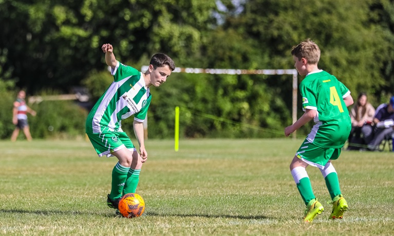 Two boys playing football