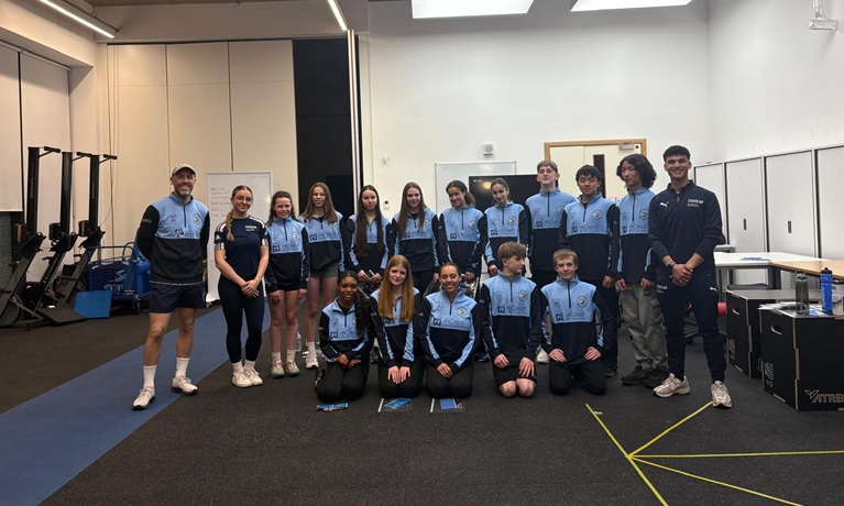 Young athletes from Team Coventry in their tracksuits inside one of Coventry University's sports labs
