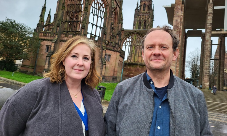 Dr Michaelina Jakala and Dr Chas Morrison from Coventry University’s Research Centre for Peace and Security outside Coventry Cathedral, where the comic exhibition will be held.