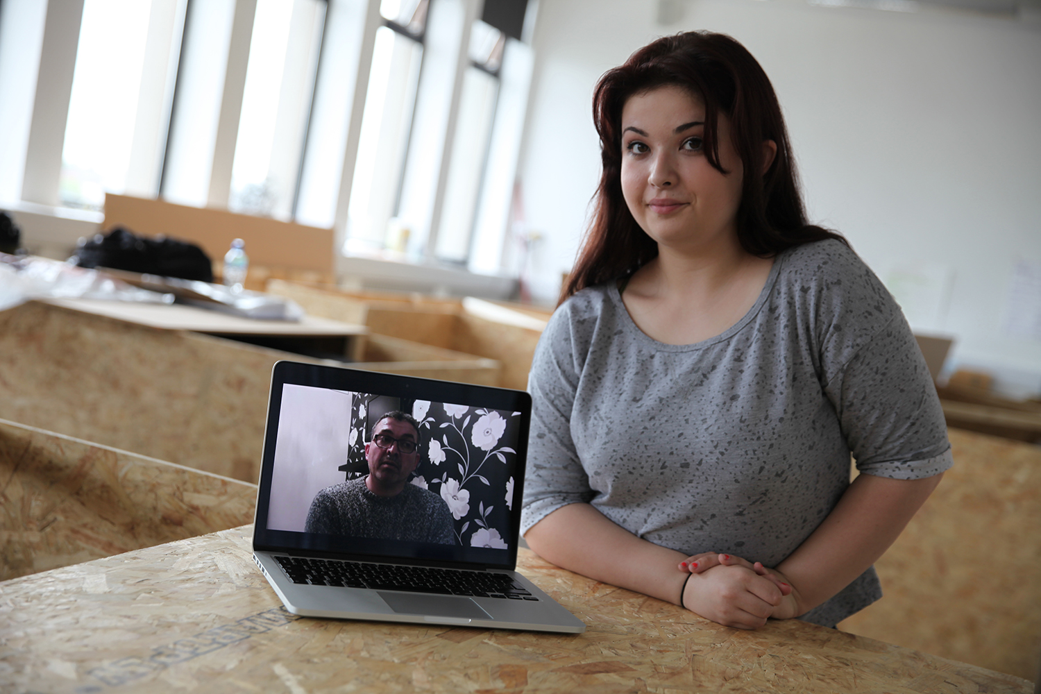 Abbie Batt showcasing her work via a laptop