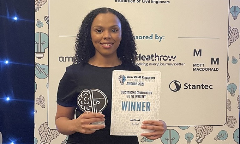 Abi Tetteh at the awards ceremony holding her award and certificate