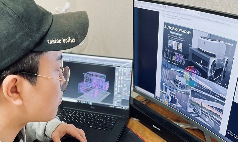 Student Hwijun Moon sitting at a computer screen working on his car design