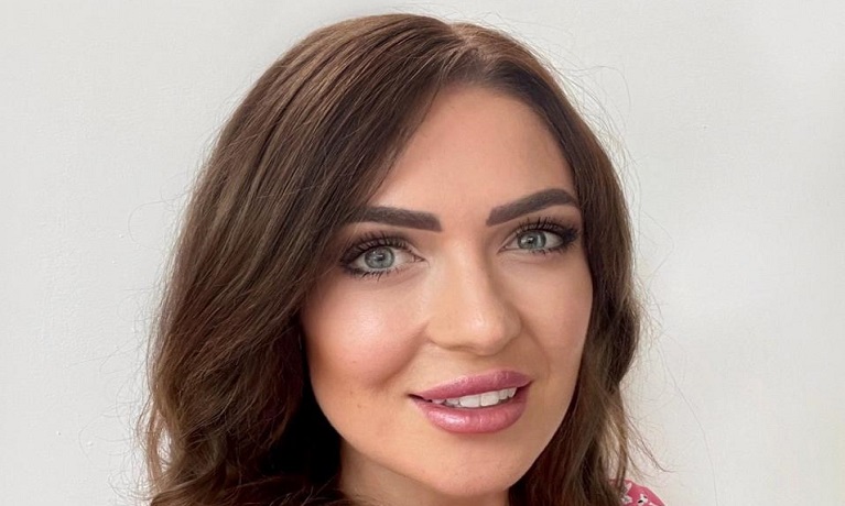 Headshot picture of a woman with brown hair