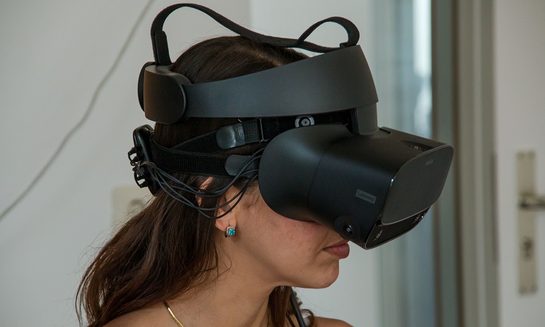 A woman with brown hair wearing a virtual reality headset