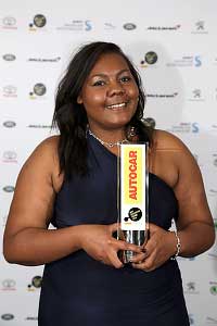 Nicole Agba holding an award