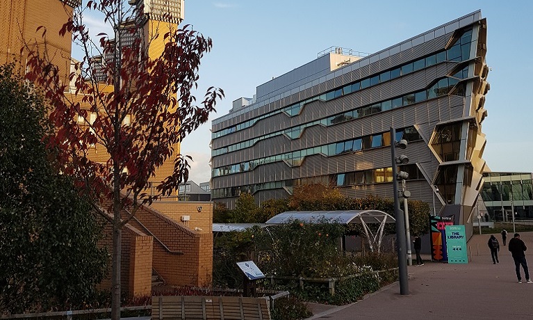 The outside of Coventry University's Frank Whittle Building with a free and part of the university library to the left-hand side