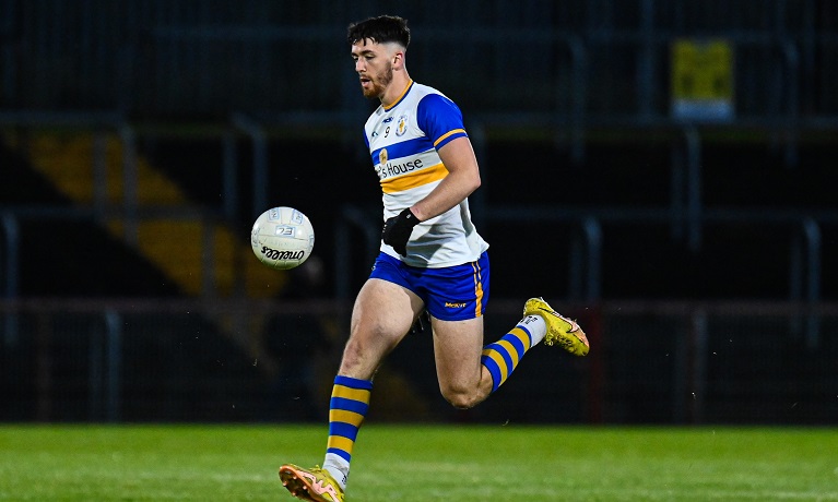 A man on a sports pitch playing Gaelic football