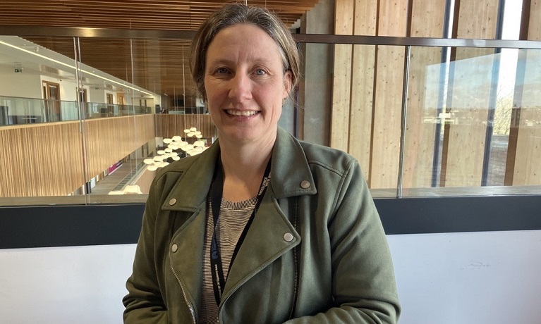 PhD student Mirabel Pelton sitting at a table