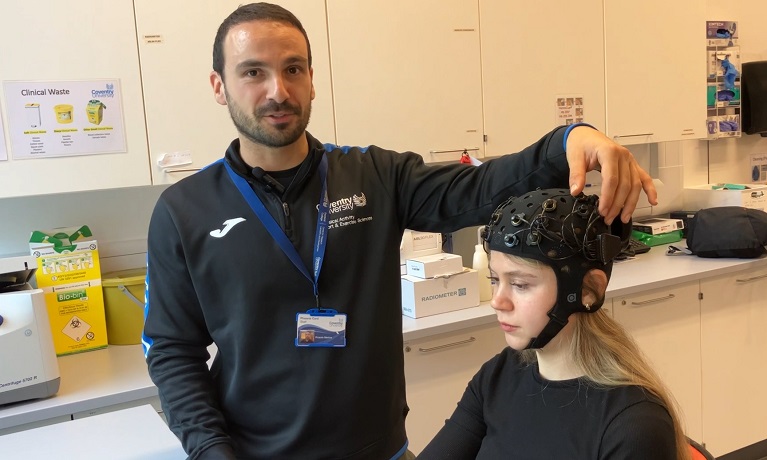 Ricardo Martins demonstrates how the FNIRS cap works