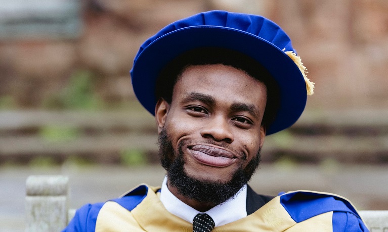 Emmanuel Johnson in postgraduate graduate outfit