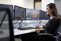 Female student working on a bloomberg terminal