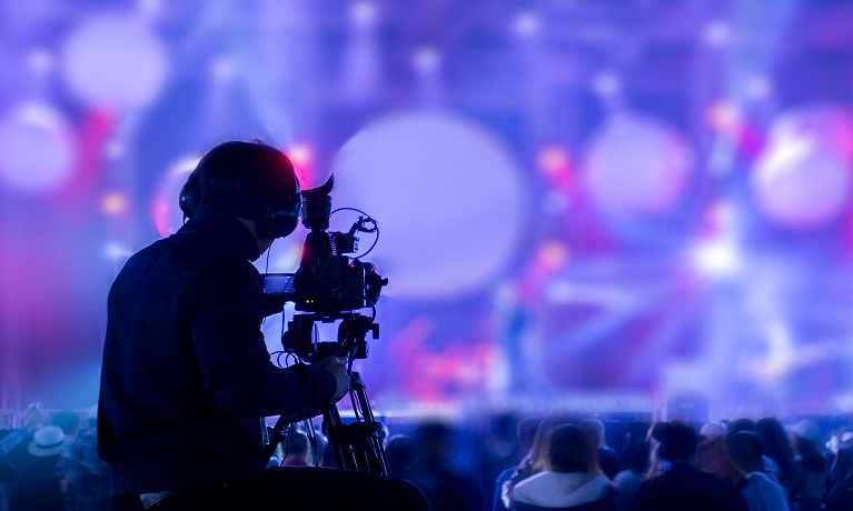 A cameraman filming a music concert