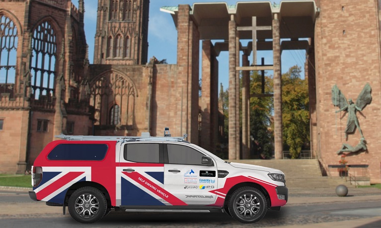 A picture of a vehicle with MACAM branding outside Coventry Cathedral