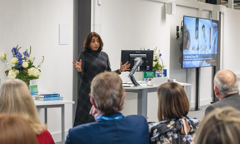 A female presenter giving a talk 