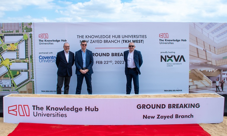 Three men in front of a banner at the groundbreaking ceremony