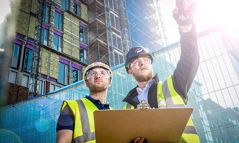 Construction managers on site front view