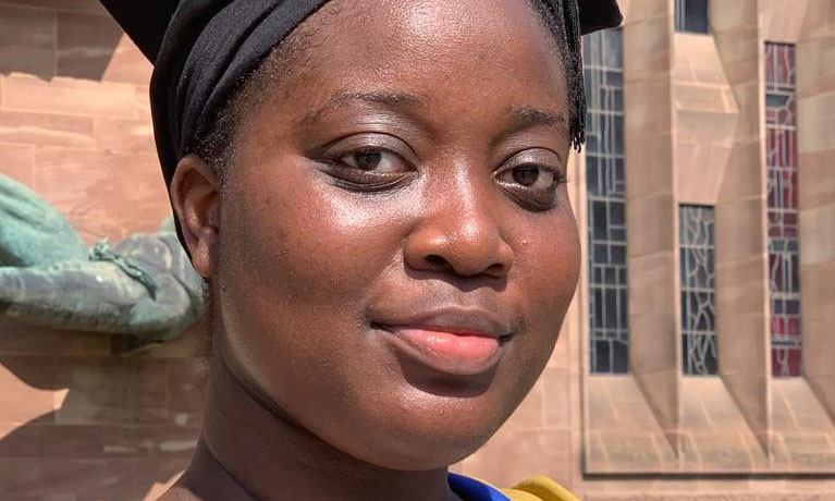 Lilian Darteh in a graduation cap and gown.