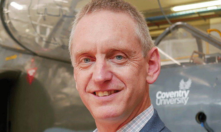 A head and shoulders picture of Professor Michael Fitzpatrick in front of an aircraft