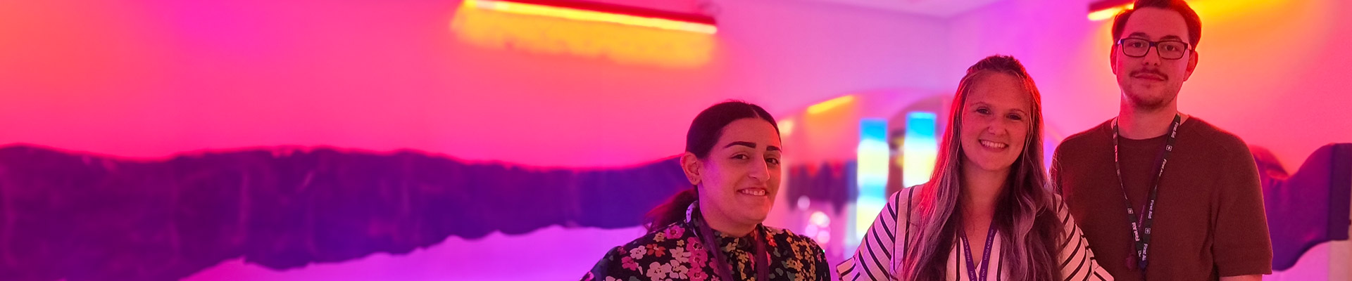 three teachers standing together in a sensory room