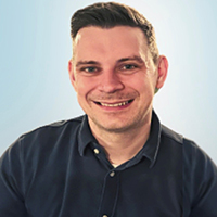 A portrait of Chris Ives with a plain background