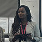 Haddy jeng smiling standing at the front of a classroom
