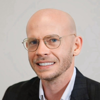 Headshot of Joshua James smiling at the camera.