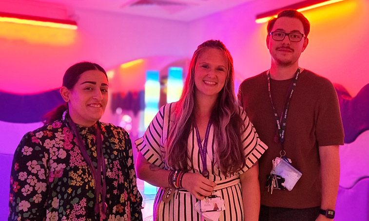 three teachers standing together in a sensory room