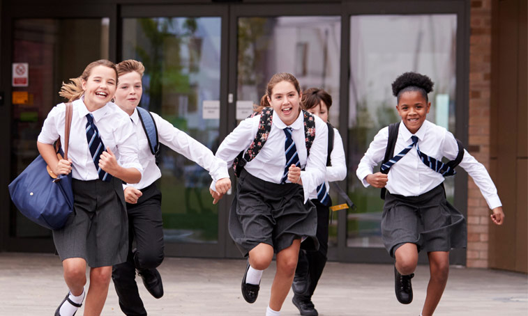 School children running outside.