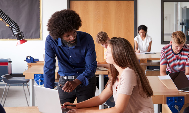 A teacher helping an older student in class