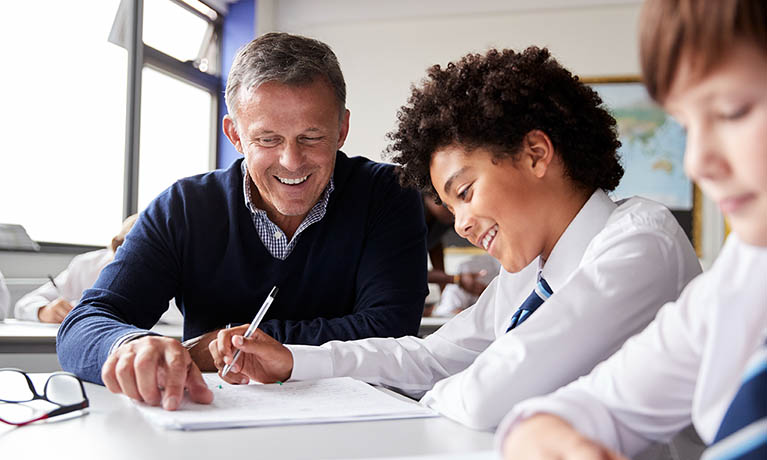 male teacher working with pupil