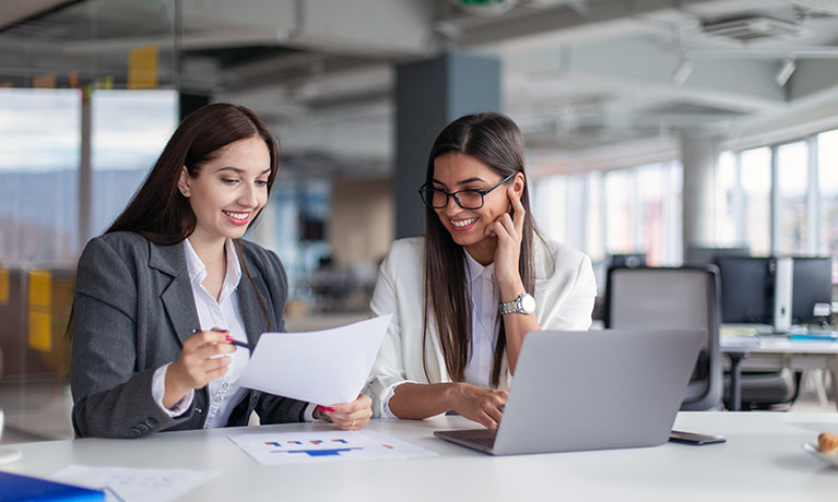 Two females working at desk