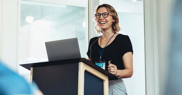 A woman on stage presenting