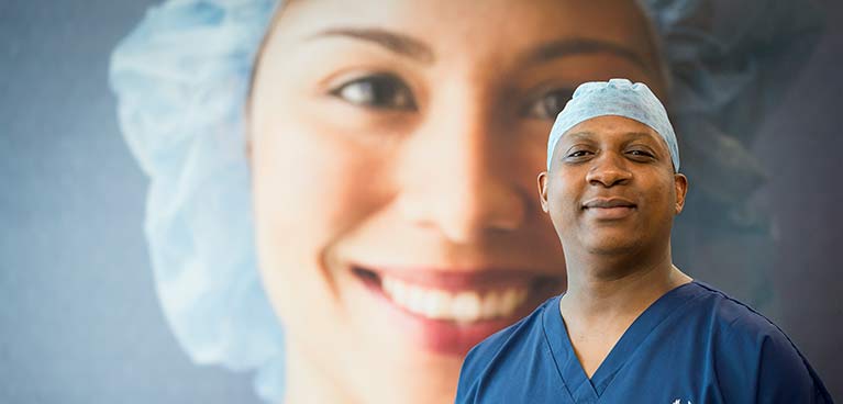 Male in scrubs with close up image of female in background