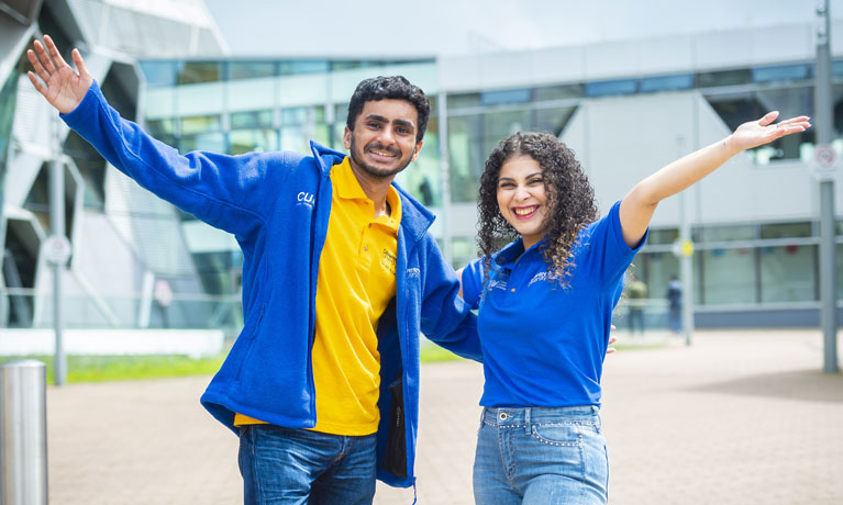 Two student open day guides outside EEC building