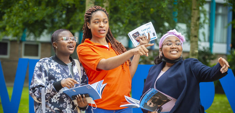 Student ambassador showing two students around campus.